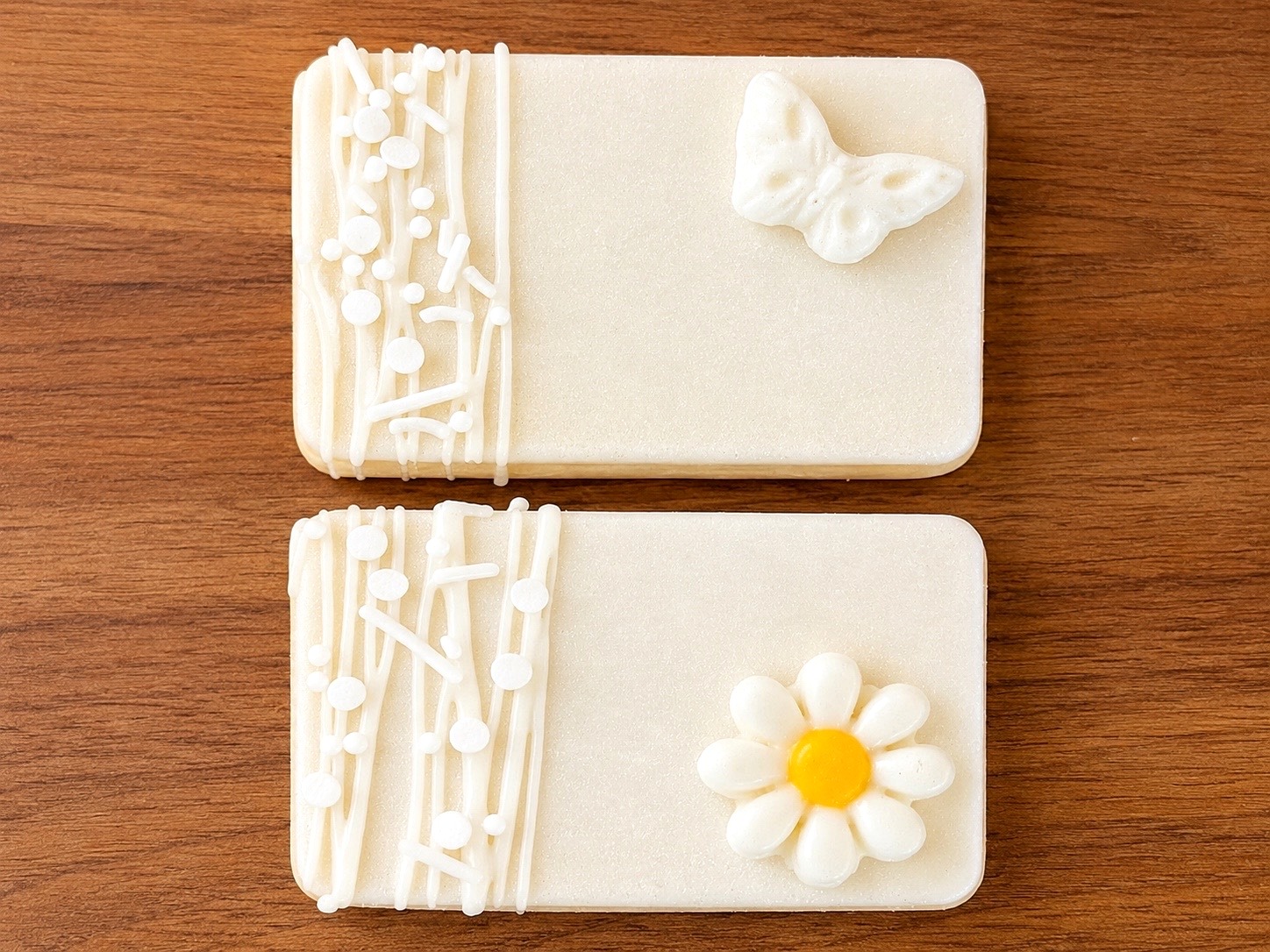 White chocolate crispy treats with butterfly and daisy details on wood background