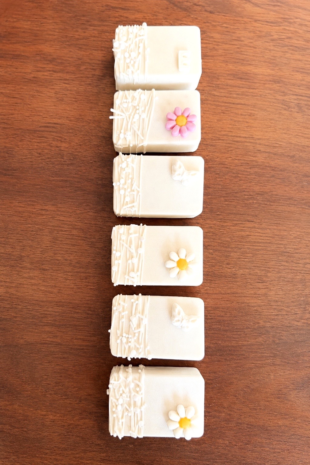 Stacked white chocolate crispy treats with pastel flower and butterfly details